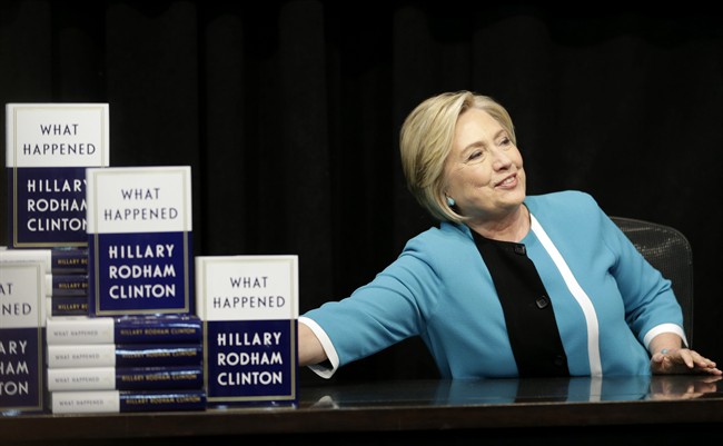 In this file photo, Hillary Rodham Clinton prepares to sign copies of her book "What Happened" at a book store in New York, Tuesday, Sept. 12, 2017.