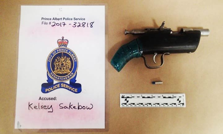 A wanted man is facing firearm charges after being arrested by police in Prince Albert, Sask.