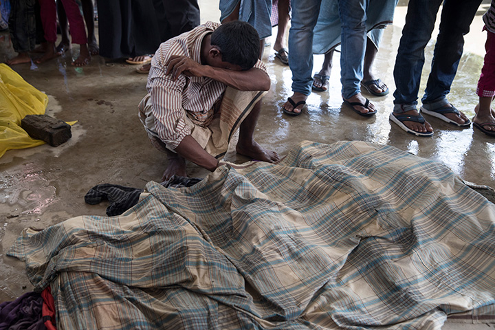 Family members mourn next to the bodies of children before the funeral after a boat sunk in rough seas off the coast of Bangladesh carrying over 100 people on September 29 in Inani , Bangladesh. 