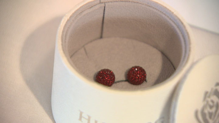 SFL selling burgundy sparkle ball earrings from Hillberg and Berk to support survivors of domestic violence in Saskatchewan.