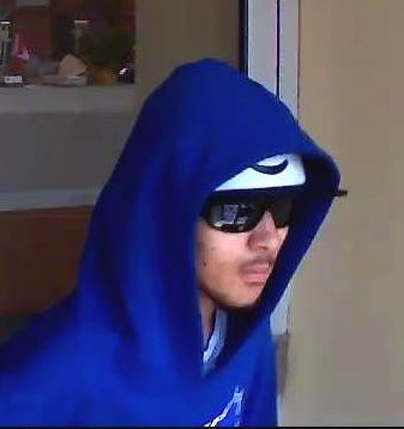 Security camera image of man wanted in robbery investigations.
