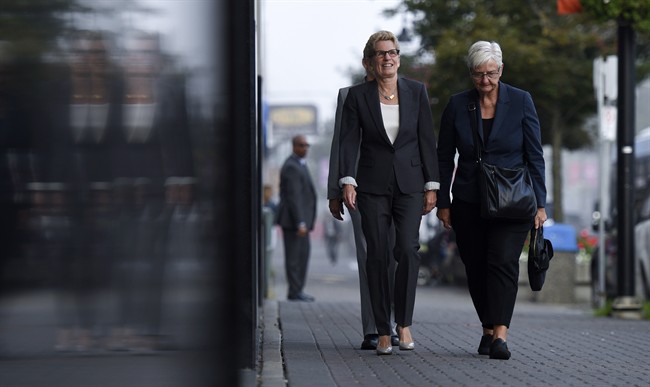 Ontario Premier Kathleen Wynne, left, arrives to appear as a witness in the Election Act bribery trial in Sudbury, Ontario, Wednesday, Sept. 13, 2017. 