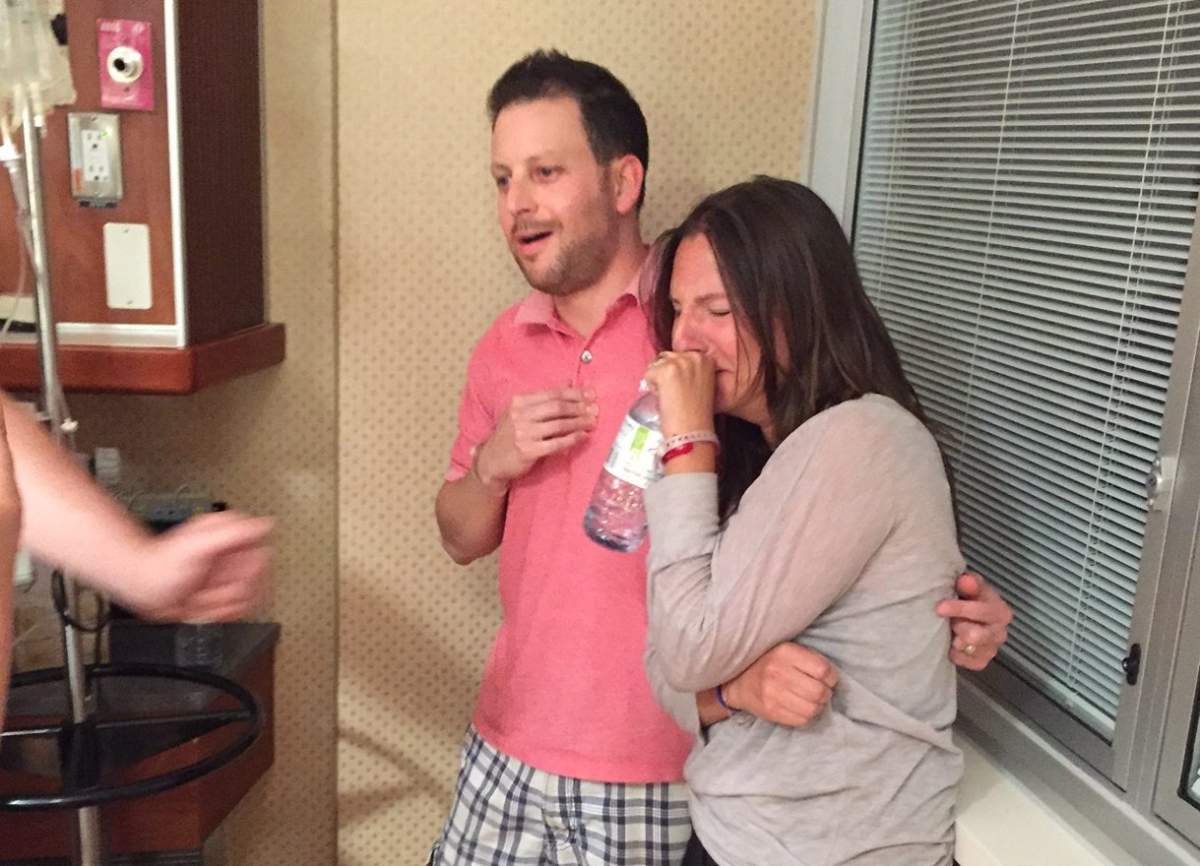 Melanie Parnass and her husband watch the birth of their son.