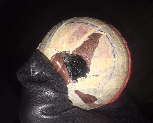 Inside the tennis ball was a black tar-like substance, consistent with opium. 