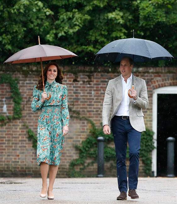 In this Wednesday, Aug. 30, 2017 file photo Britain's Prince William and his wife Kate, Duchess of Cambridge smile as they arrive at the memorial garden in Kensington Palace, London.