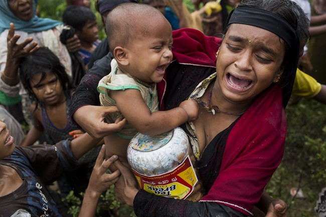 In this Sept. 8, 2017, photo, a Rohingya woman breaks down after a fight erupted during food distribution by local volunteers at Kutupalong, Bangladesh, Friday, Sept. 8, 2017.