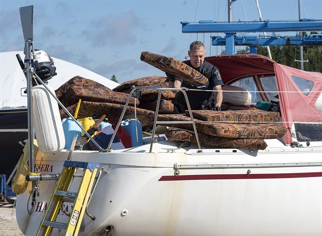 A Canada Border Services Agency officer inspects the sailboat Quesera at East River Marine in Hubbards, N.S., on Friday, Sept. 8, 2017. Approximately 273 kilograms of suspected cocaine were found on the vessel and two men were arrested.