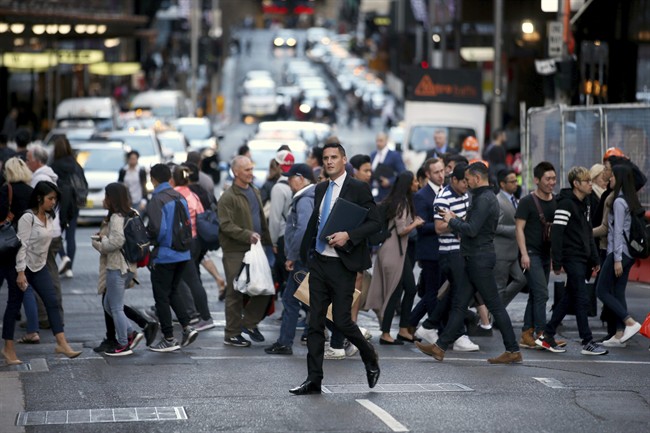 People move about the city as the working day nears its end in Sydney, Wednesday, Sept. 6, 2017. 
