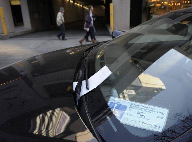 An Accessible Parking Permit is displayed on the dash of a vehicle parked in the Yorkville neighbourhood of Toronto, April 1, 2010.