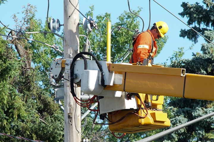 In this 2013 file photo, Hydro-Quebec crews are at work restoring power to the district of Sainte-Rose in Laval after a massive thunderstorm toppled trees onto power lines.
