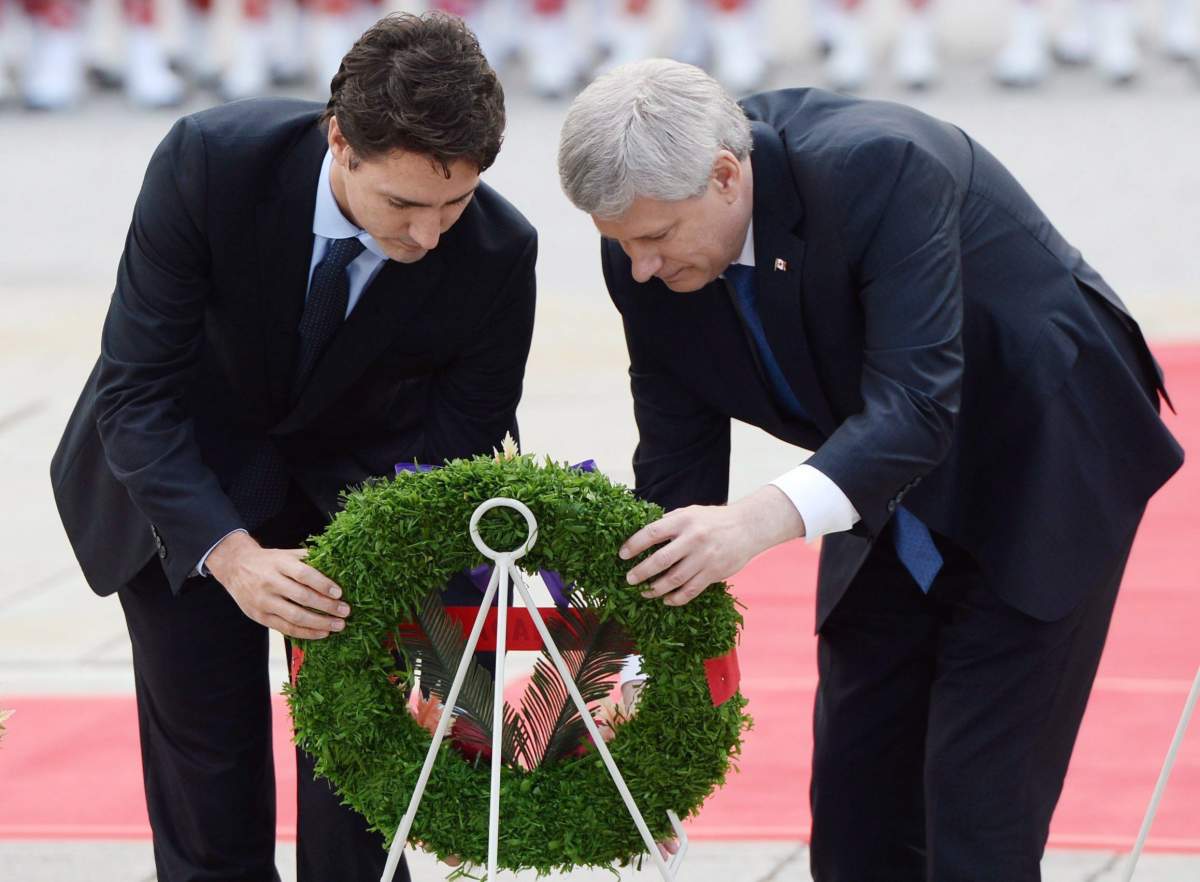 Then-Prime Minister Stephen Harper, left, and Justin Trudeau, then-prime minister-designate of Canada, place a wreath at a ceremonial service on Parliament Hill in Ottawa on Thursday, Oct. 22, 2015 to commemorate the attack on and the lives of Corporal Nathan Cirillo and Warrant Officer Patrice Vincent.