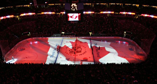 A Canadian flag illuminates the rink during the Canada national anthem before a Calgary Flames game, Oct. 10, 2005.