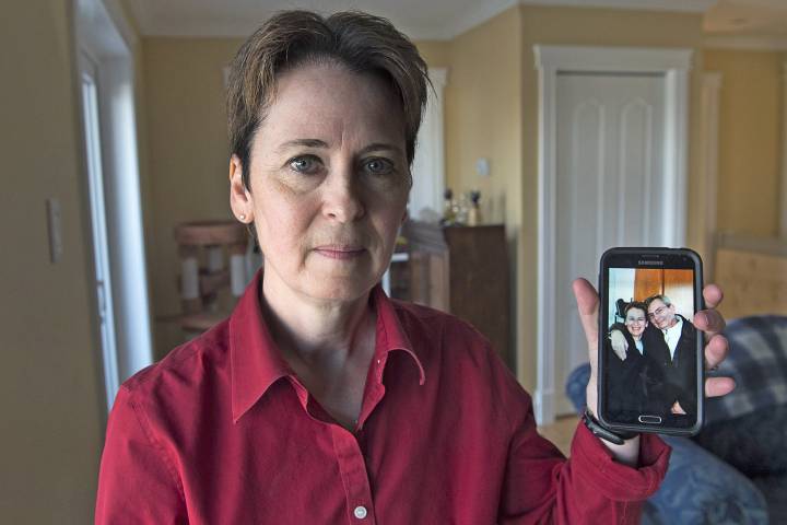 Kim D'Arcy displays an image of her late husband Jack Webb at her home in Bedford, N.S. on Thursday, April 13, 2017. Webb died after being diagnosed with pancreatic cancer but not before enduring a difficult ordeal with a health care system that is grappling with the pressures of overcapacity.