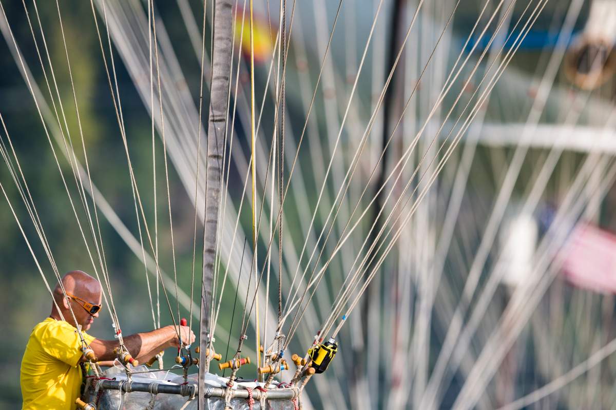 FILE: A crew member performs a last-minute check on a balloon before the start of the 61st Gordon Bennett Aeronautical Cup in Gruyeres, Switzerland, 08 September 2017.
