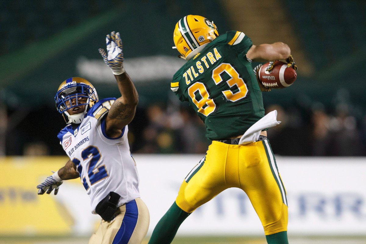 Winnipeg Blue Bombers' Brian Walker (22) tries to stop Edmonton Eskimos' Brandon Zylstra (83) from catching the ball during second half CFL action in Edmonton, Alta., on Saturday September 30, 2017. 