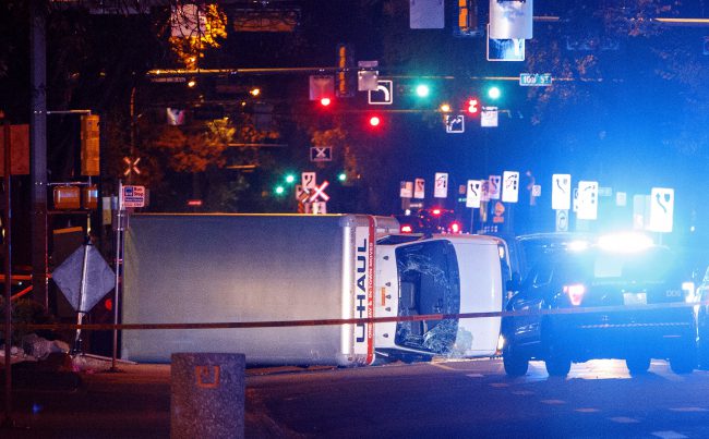 Police investigate the scene after a cube van ran into pedestrians and later flipped over while being pursued by police, in Edmonton Alta, on Saturday September 30, 2017. 
