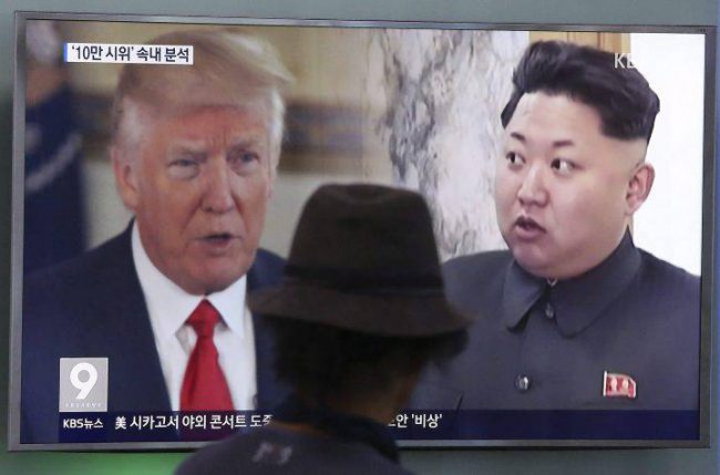A man watches a television screen showing U.S. President Donald Trump, left, and North Korean leader Kim Jong Un during a news program at the Seoul Train Station in Seoul, South Korea. 