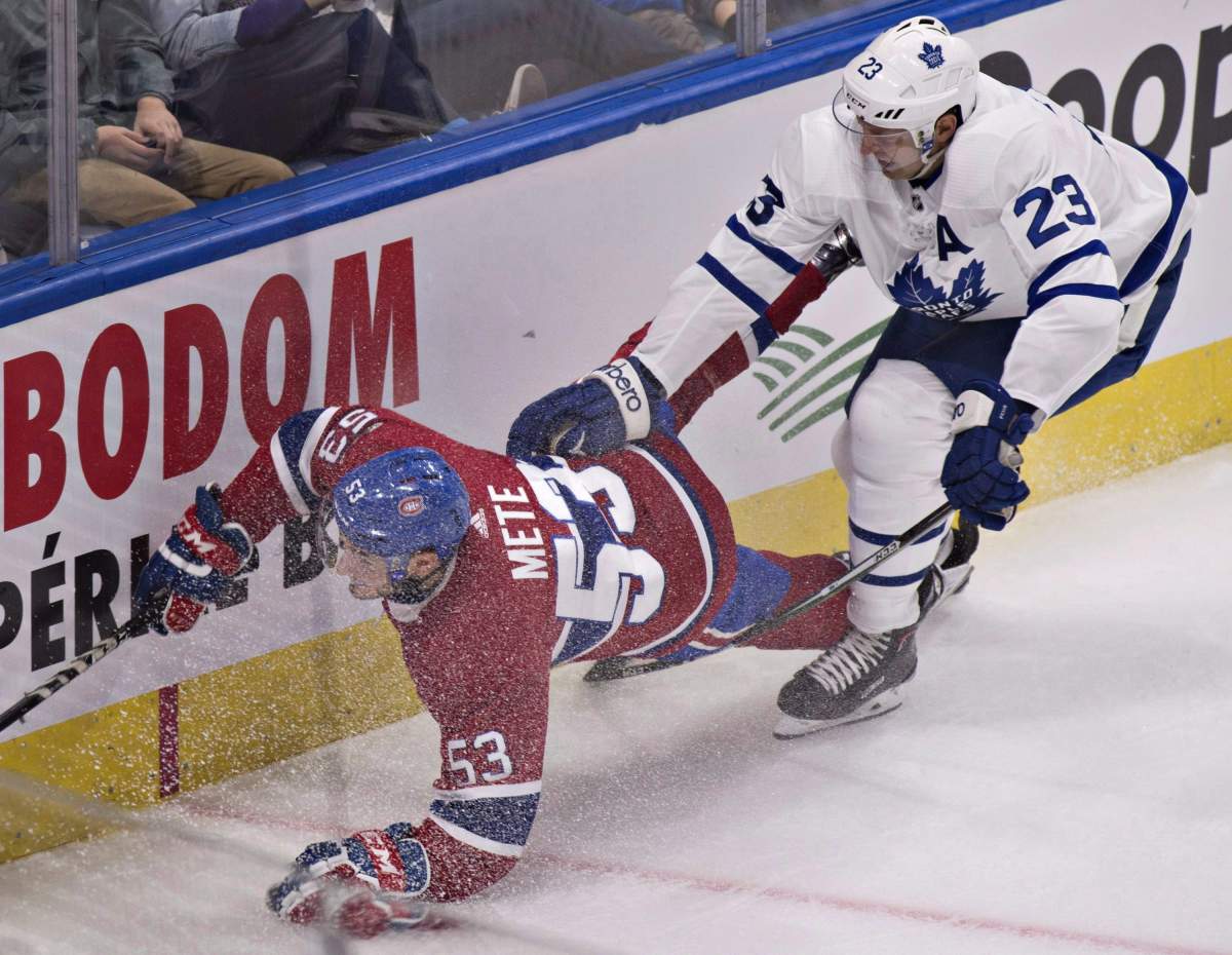 Montreal Canadiens' Victor Mete is tripped by Toronto Maple Leafs' Eric Fehr during second period NHL pre-season action Wednesday, September 27, 2017 in Quebec City.There is a youth movement on the Canadiens, as junior-age defenceman Mete, rookie Charles Hudonand centre Jacob De La Rose all are expected to at least start the NHL season in Montreal. THE CANADIAN PRESS/Jacques Boissinot.