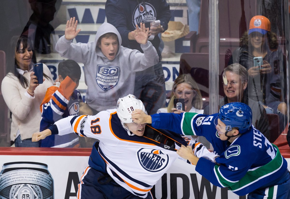 Edmonton Oilers' Ryan Strome, left, and Vancouver Canucks' Troy Stecher fight during the second period of an NHL hockey game in Vancouver, B.C., on Saturday, October 7, 2017. THE CANADIAN PRESS/Darryl Dyck.