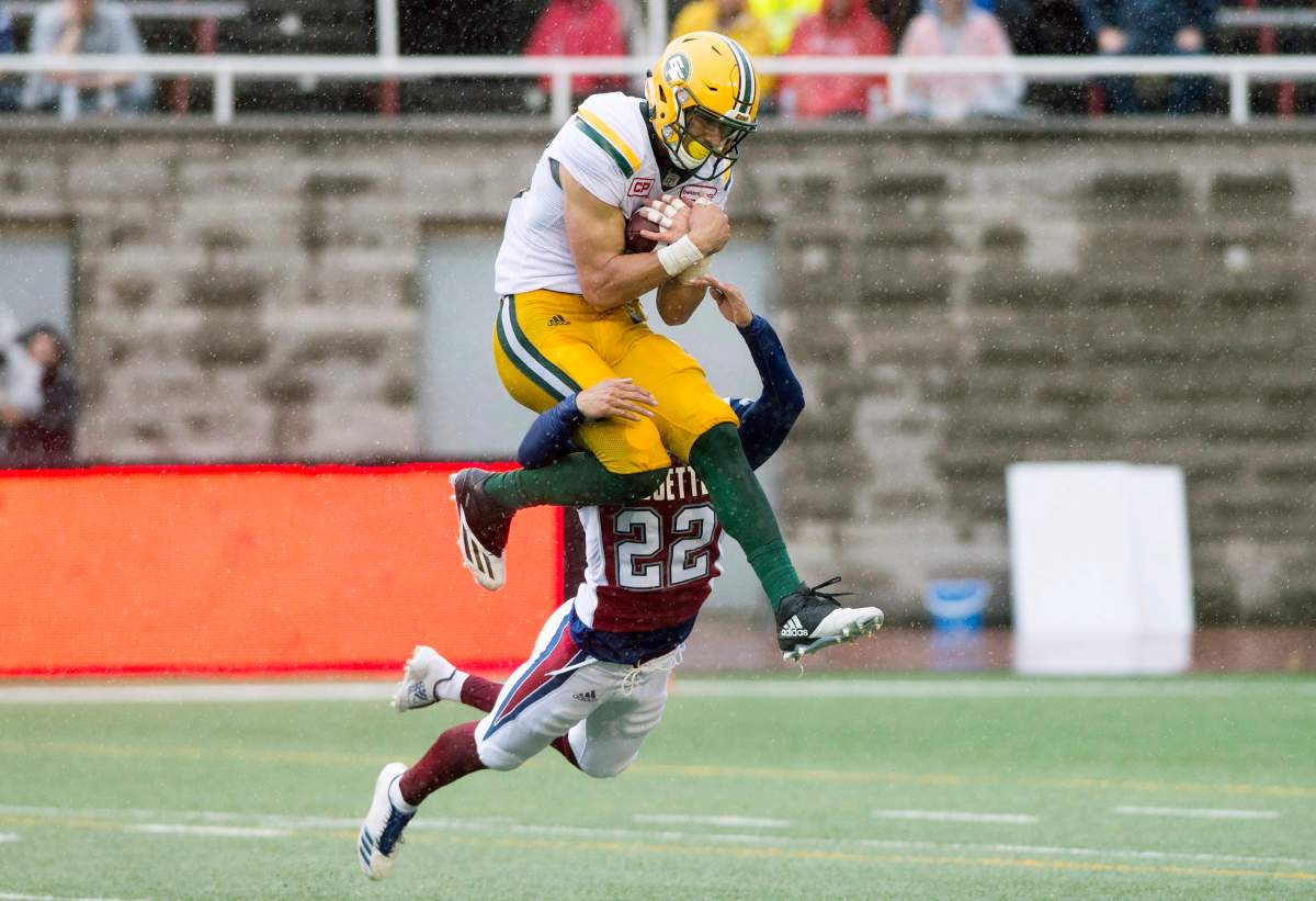 Edmonton Eskimos' Brandon Zylstra makes a catch as Montreal Alouettes' Greg Henderson defends during first half CFL football action in Montreal, Monday, October 9, 2017. 