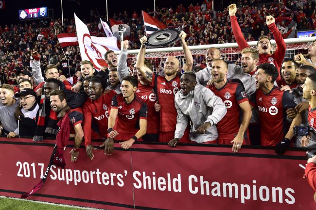 The Toronto FC celebrate with the Supporters' Shield following their win over the Montreal Impact in MLS soccer action in Toronto, Oct. 15, 2017. 
