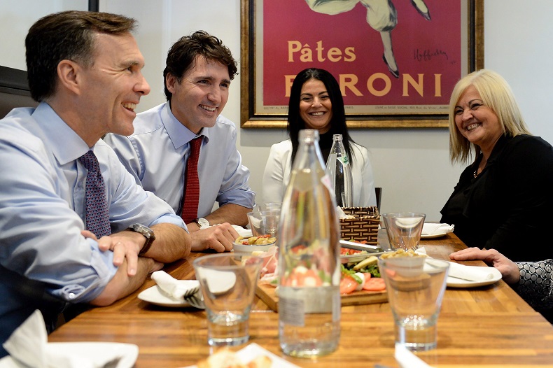 Finance Minister Bill Morneau and Prime Minister Justin Trudeau chat over lunch with the owners of Pastaggio Italian Eatery, a family-run restaurant in Stouffville, Ont., on Oct. 16, 2017.