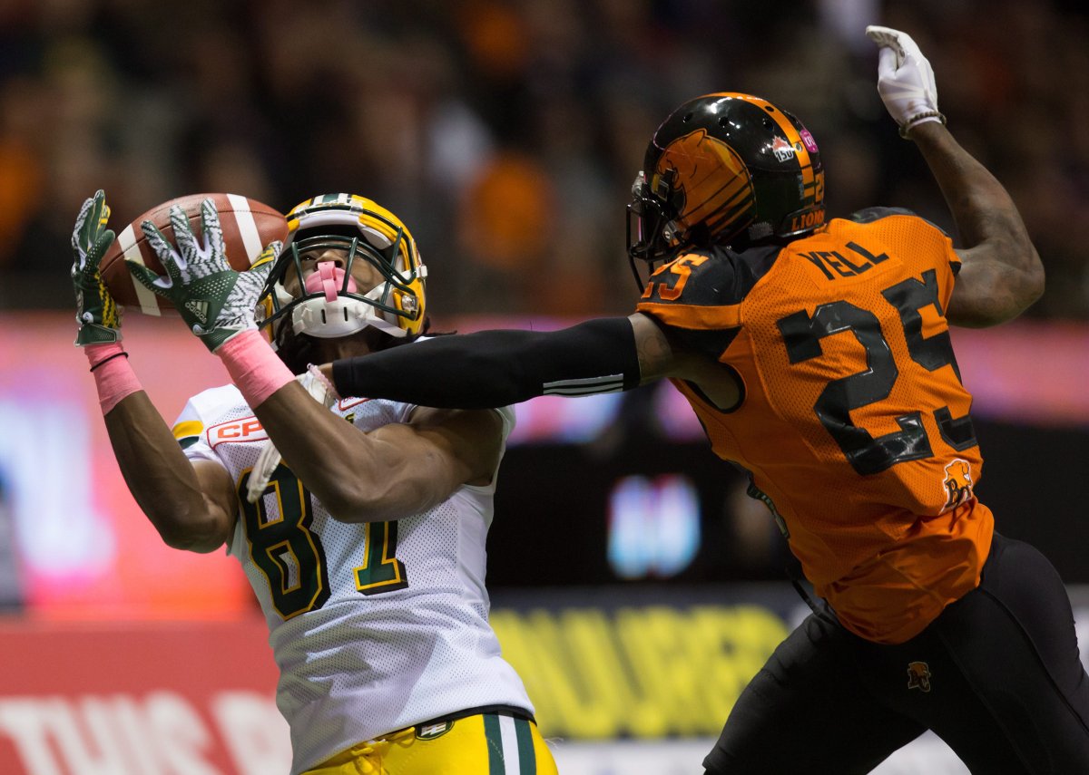 Edmonton Eskimos' Derel Walker, left, makes a reception in front of B.C. Lions' Ronnie Yell during the second half of a CFL football game in Vancouver, B.C., on Saturday October 21, 2017. THE CANADIAN PRESS/Darryl Dyck.