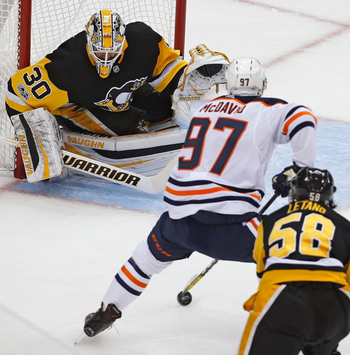 Edmonton Oilers' Connor McDavid (97) goes to the backhand in front of Pittsburgh Penguins goalie Matthew Murray (30) with Kris Letang (58) defending in the first period of an NHL hockey game in Pittsburgh, Tuesday, Oct. 24, 2017. McDavids shot went wide. (AP Photo/Gene J. Puskar).