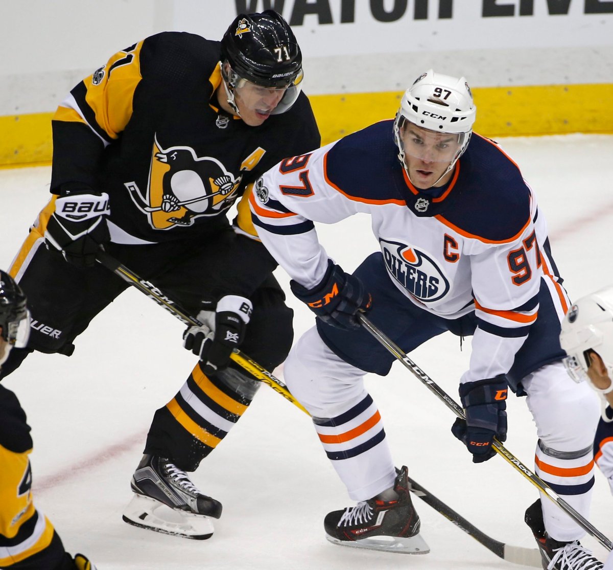 Pittsburgh Penguins' Evgeni Malkin (71) works for position against Edmonton Oilers' Connor McDavid (97) in the first period of an NHL hockey game in Pittsburgh, Tuesday, Oct. 24, 2017. (AP Photo/Gene J. Puskar).