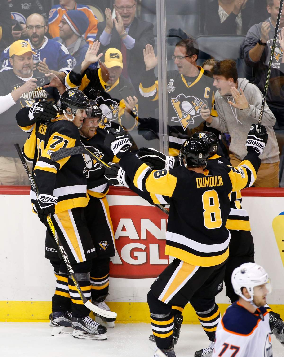 Pittsburgh Penguins’ Phil Kessel, second from left, celebrates his game winning goal against the Edmonton Oilers in overtime with teammate Evgeni Malkin (71) at the end of an NHL hockey game in Pittsburgh, Tuesday, Oct. 24, 2017. The Penguins won 2-1. (AP Photo/Gene J. Puskar)