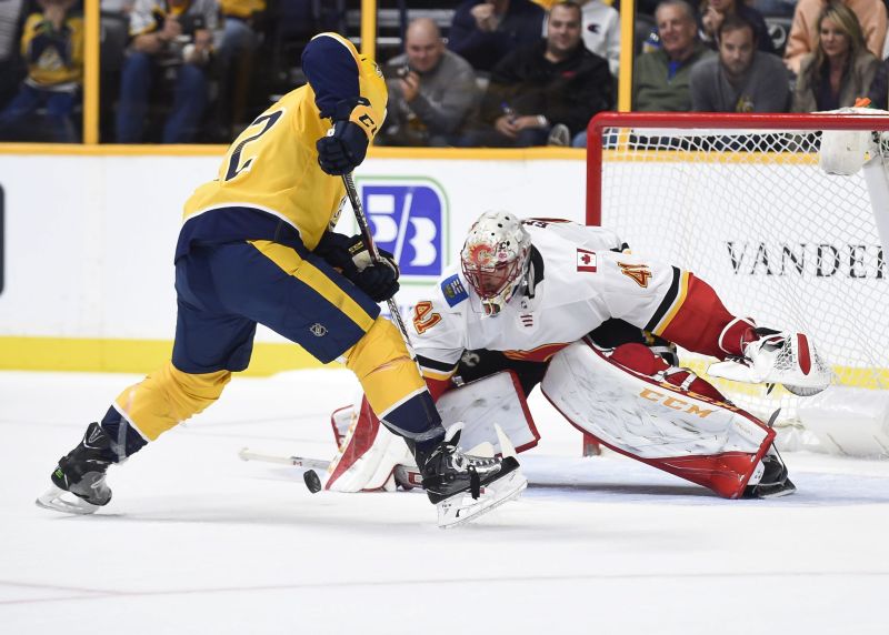 Calgary Flames goalie Mike Smith (41) blocks the shot of Nashville Predators left wing Kevin Fiala (22) during the shootout between the Calgary Flames vs the Nashville Predators at Bridgestone Arena. 