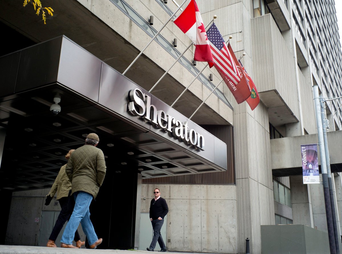 People walk past the entrance to the Sheraton Place, in Toronto on Friday, October 27, 2017. The Sheraton Centre hotel in downtown Toronto has been purchased for $335 million by an arm of Brookfield Asset Management Inc. The deal is the largest-ever single hotel transaction in Canadian history, says CBRE Canada, who acted as the broker for Marriott International. 