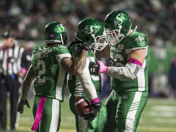 Saskatchewan Roughriders running back Trent Richardson (33) celebrates his touchdown with teammates wide receiver Chad Owens (2) and offensive lineman Dariusz Bladek (66) during second half CFL football action against the Montreal Alouettes in Regina on Friday, October 27, 2017.