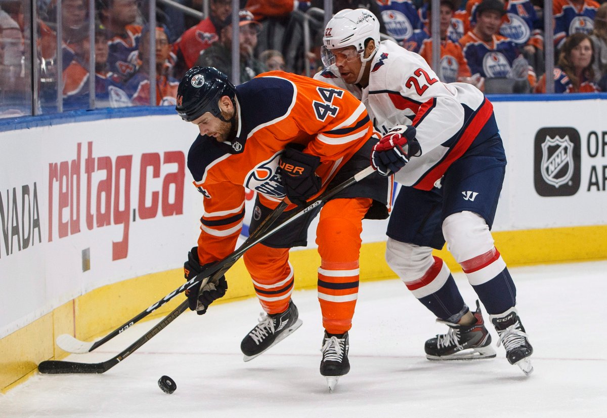 Washington Capitals' Madison Bowey (22) and Edmonton Oilers' Zack Kassian (44) battle for the puck during second period NHL action in Edmonton, Alta., on Saturday October 28, 2017. THE CANADIAN PRESS/Jason Franson.