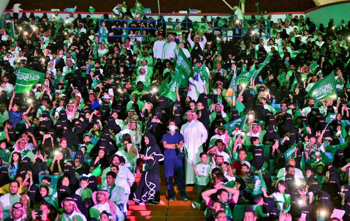  In this Sept. 23, 2017 file photo released by Saudi Press Agency, SPA, Saudi men and women attend national day ceremonies at the King Fahd stadium in Riyadh, Saudi Arabia. 