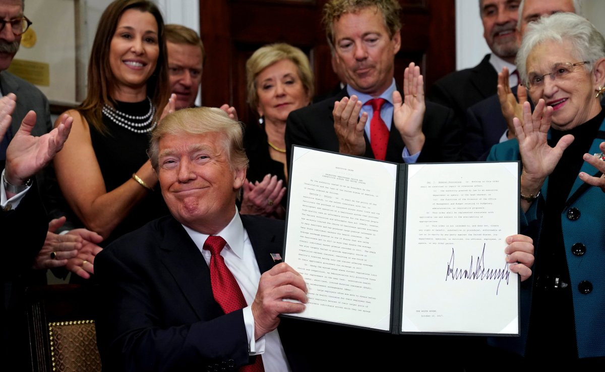U.S. President Donald Trump smiles after signing an Executive Order to make it easier for Americans to buy bare-bone health insurance plans and circumvent Obamacare rules at the White House in Washington, U.S., October 12, 2017.  