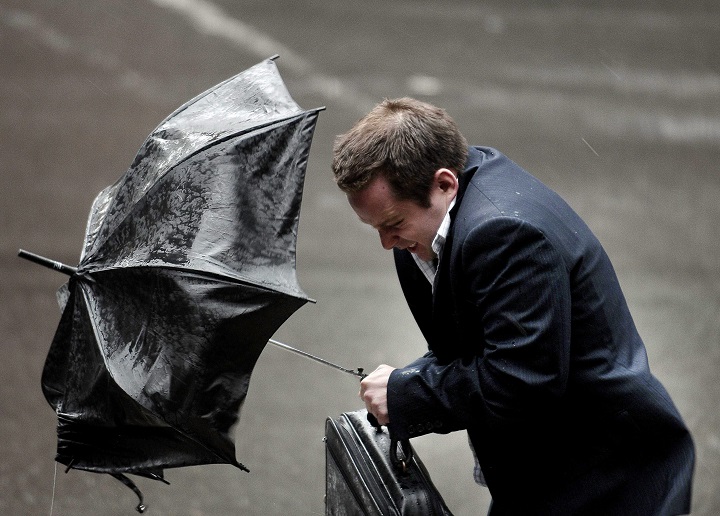 In this April 2008 file photo, a man struggles with his umbrella in the wind and the rain along St-Laurent Boulevard in Montreal. 