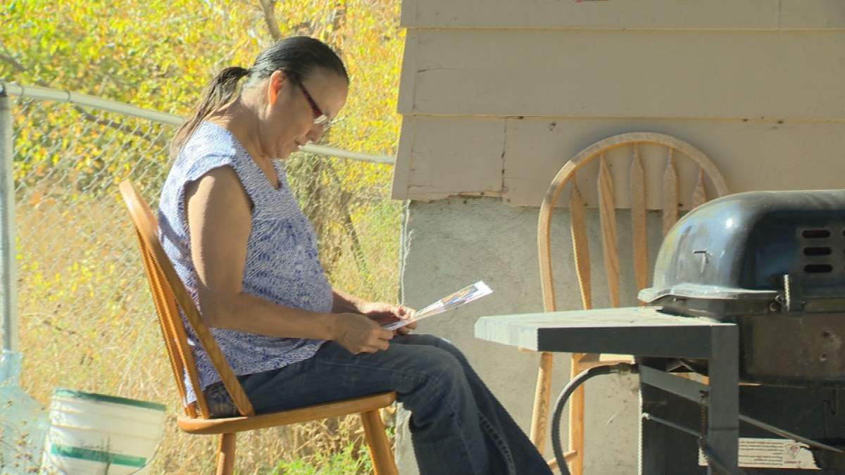 Melinda Dobson looks at a collage of pictures of her children and her youth.