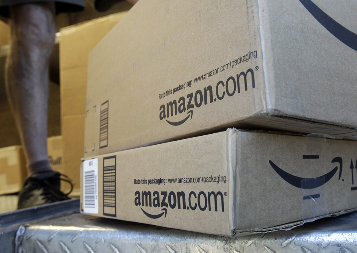 In this June 30, 2011, file photo, a United Parcel Service driver delivers packages from Amazon.com in Palo Alto, Calif. 