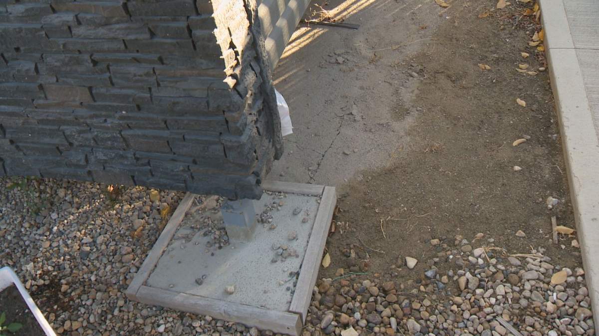 Fissures form in the dry ground near pilings on Steve Bauer’s property.