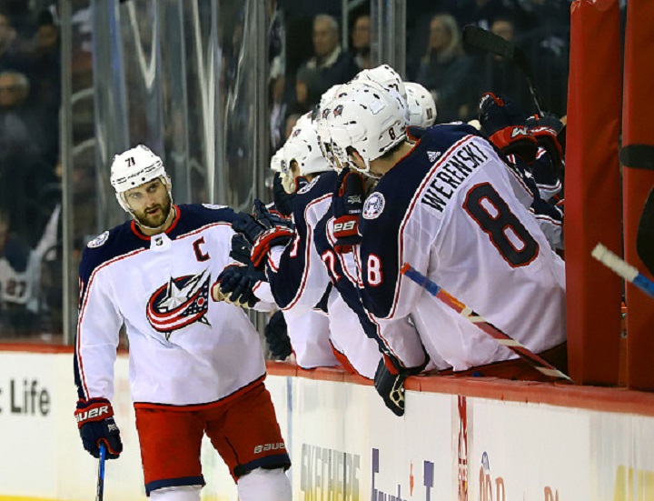 Nick Foligno #71 of the Columbus Blue Jackets celebrates his second period goal against the Winnipeg Jets with teammates at the bench at the Bell MTS Place on October 17, 2017 in Winnipeg, Manitoba, Canada. (Photo by Darcy Finley/NHL via Getty Images).