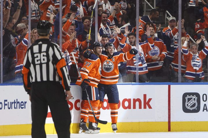 Edmonton Oilers’ Oscar Klefbom (77) and Connor McDavid (7) celebrate a goal against the Calgary Flames during first period NHL action in Edmonton, Alta., on Wednesday October 4, 2017.