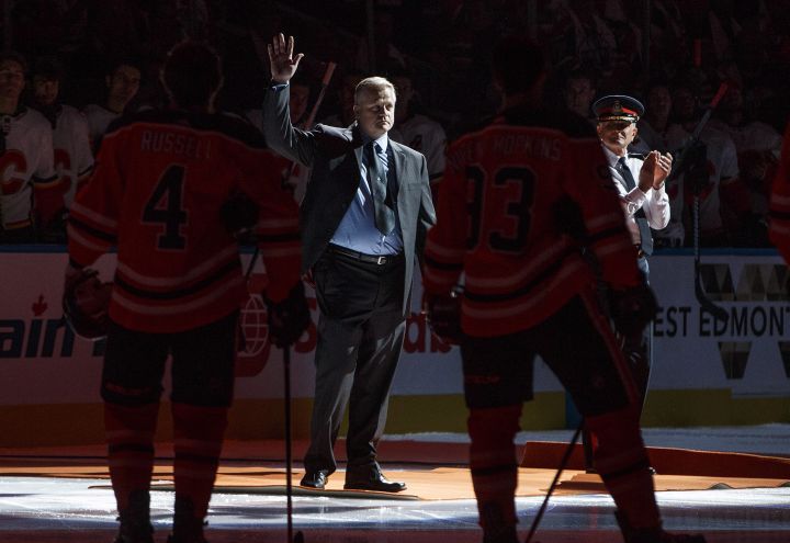 Const. Michael Chernyk waves to the crowd as he is honoured during the Calgary Flames and Edmonton Oilers game in Edmonton, Alta., on Wednesday October 4, 2017. Const. Michael Chernyk was hit by a car and stabbed during a recent attack.
