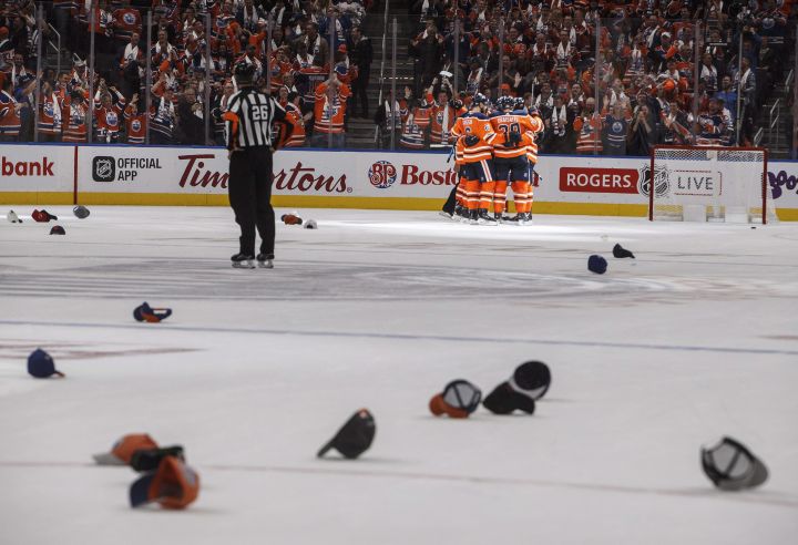 Edmonton Oilers' Connor McDavid (97) celebrates his hat trick with teammates against the Calgary Flames during third period NHL action in Edmonton, Alta., on Wednesday October 4, 2017. 