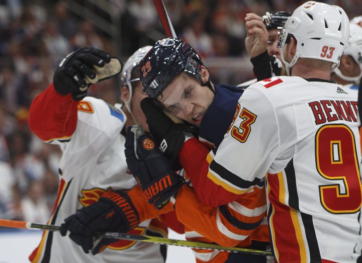 Calgary Flames’ Sam Bennett (93) grabs Edmonton Oilers’ Leon Draisaitl (29) during second period NHL action in Edmonton, Alta., on Wednesday October 4, 2017.
