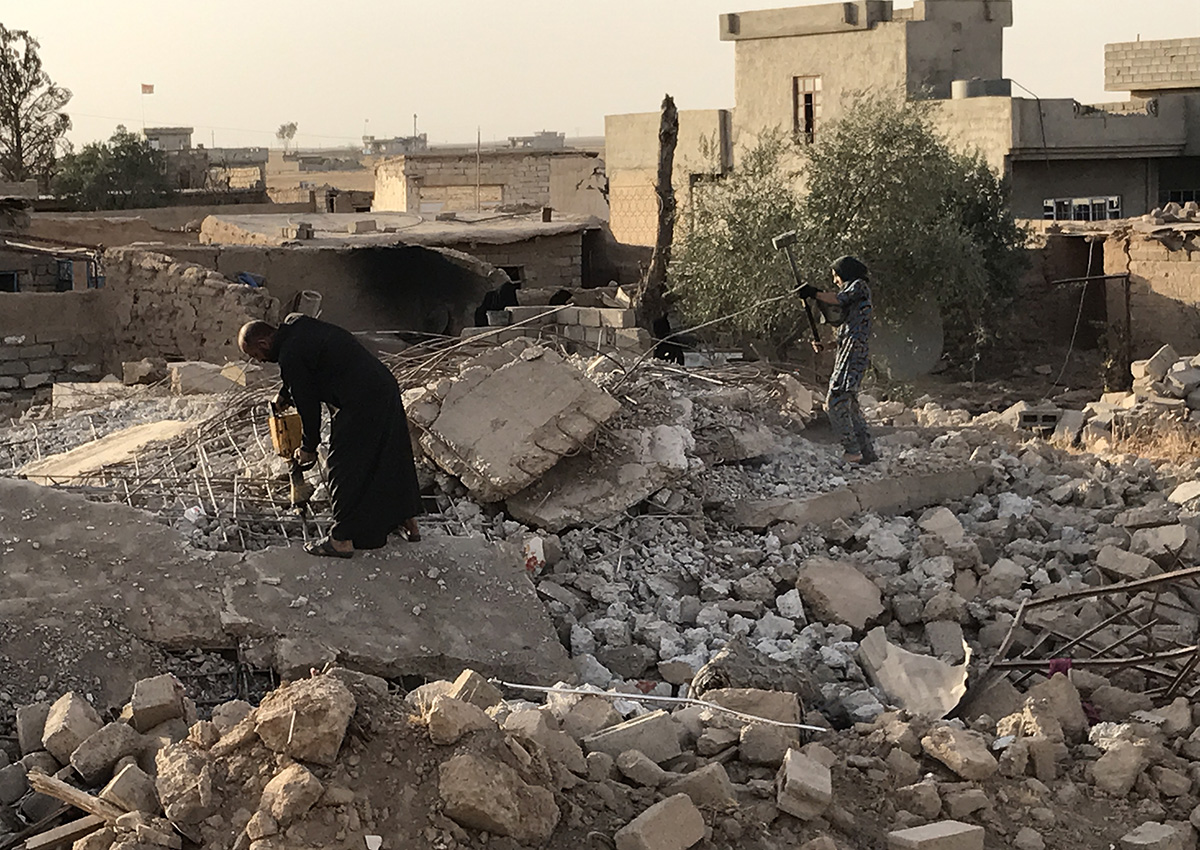 families working to clear the rubble and rebuild their homes in Nineveh.