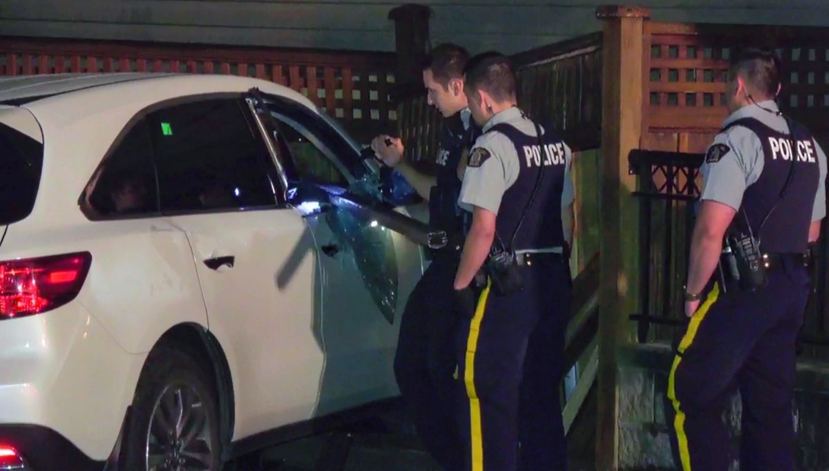 A metal pole sticks out of the SUV that crashed into a fence outside a Burnaby home early Sunday morning.