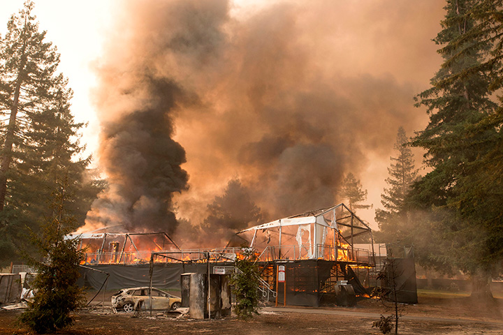 A tent structure built for the 2017 Safeway Open burns on a golf course at the Silverado Resort and Spa in Napa, California on October 9, 2017.