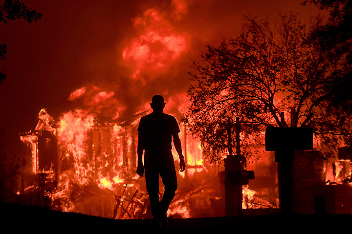 A resident watches part of his neighbourhood burn in Fountaingrove, California, Monday Oct. 9, 2017.