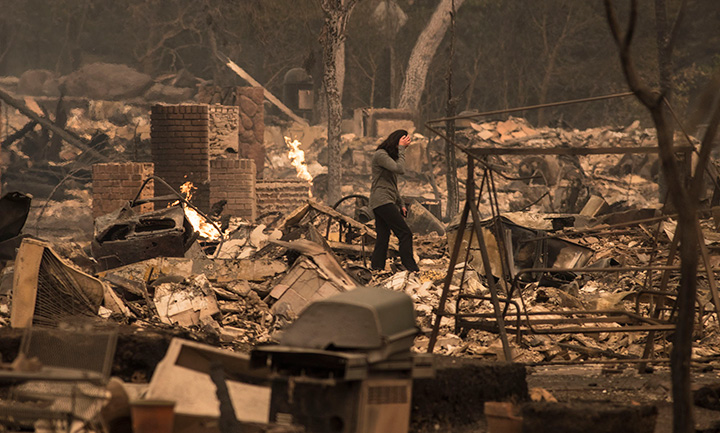 A homeowner surveys her destroyed house in Santa Rosa, California on October 9, 2017.